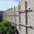 For some plants you can forgo staking the trellis into the ground and combine art with trellising like this one from Arizona Trellis. These trellises need to be anchored to a very sturdy wall, so make sure you have more than just lamination to drill into (and permission if you're renting.)